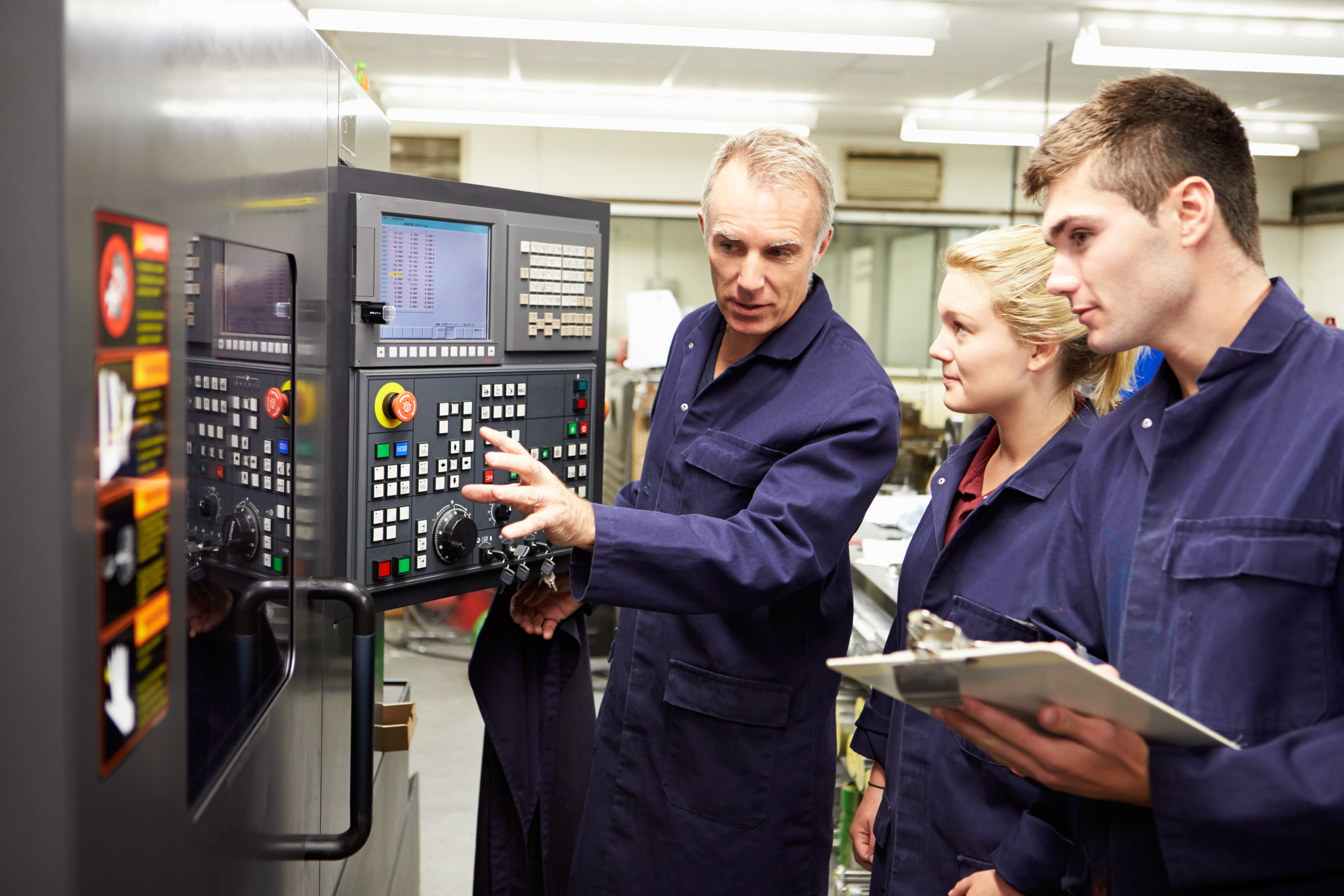 Engineer,Teaching,Apprentices,To,Use,Computerized,Lathe